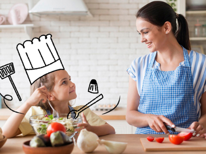 Mulher e criança cozinhando juntas, criança usando chapéu de chef em desenho, legumes no balcão