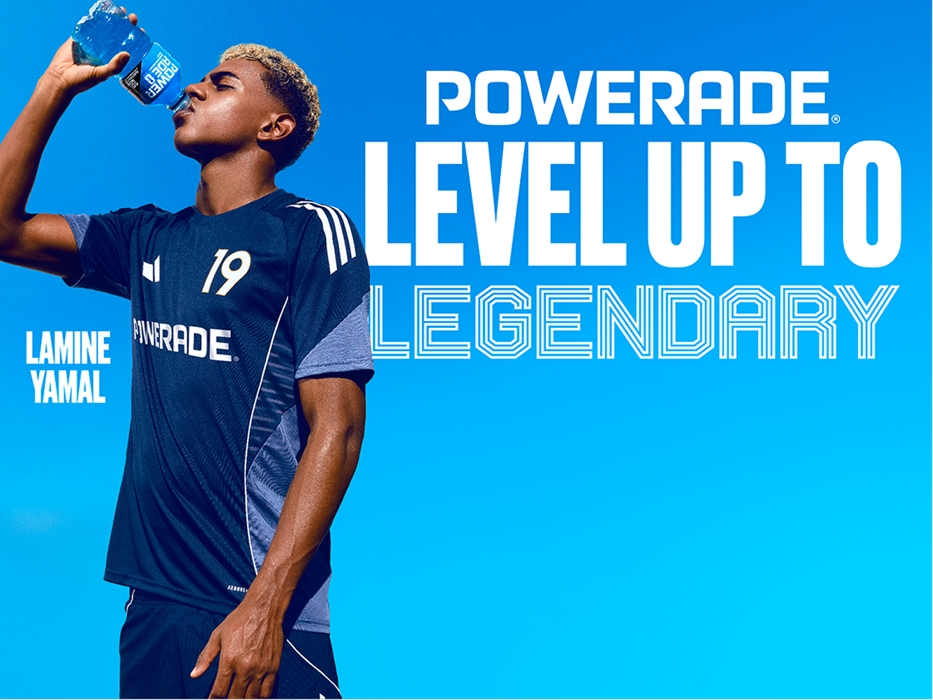 Powerade Level Up to Legendary banner with soccer player in navy kit drinking blue Powerade against bright blue sky.