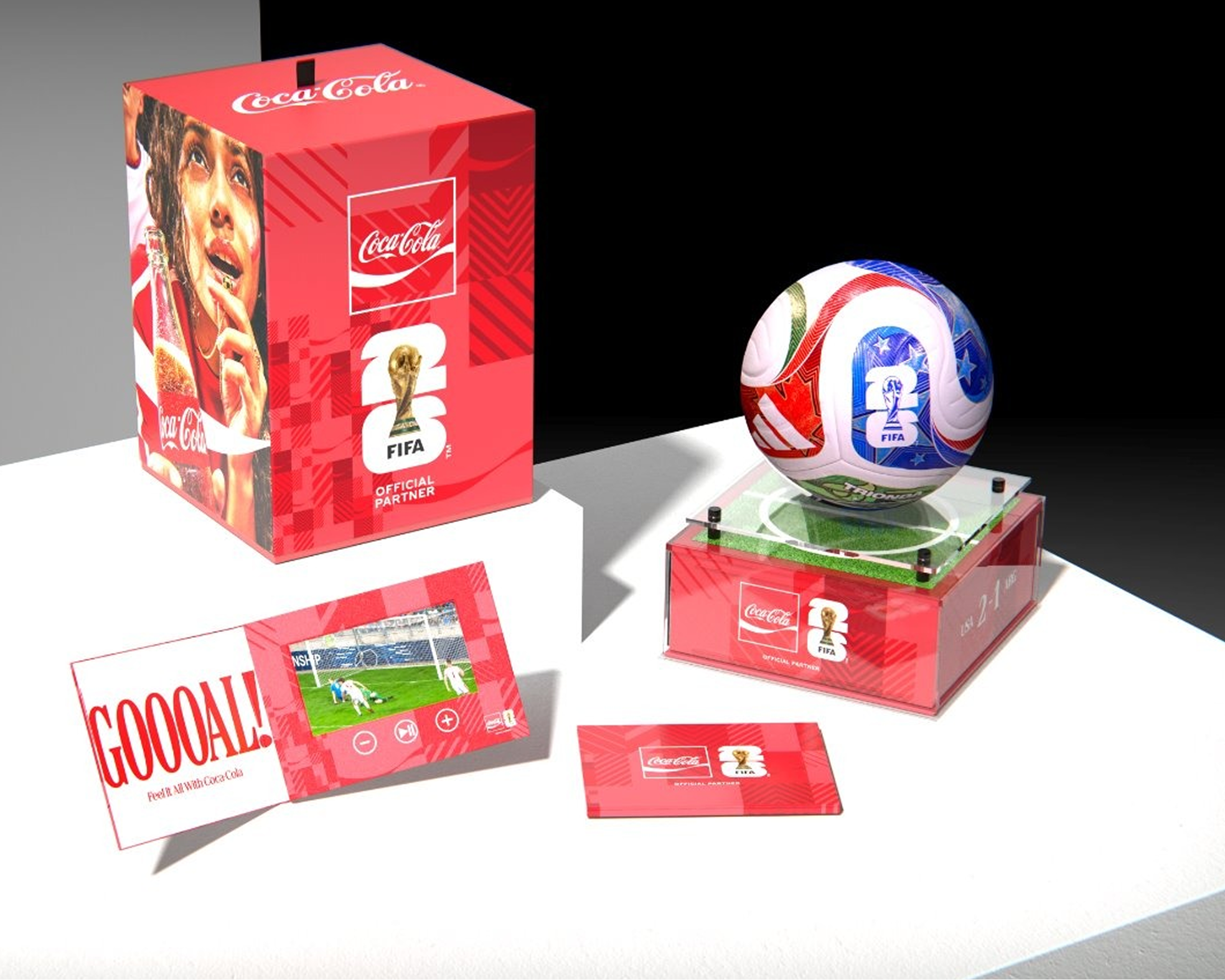 Coca-Cola FIFA match ball in clear display case beside red gift box and goal booklet