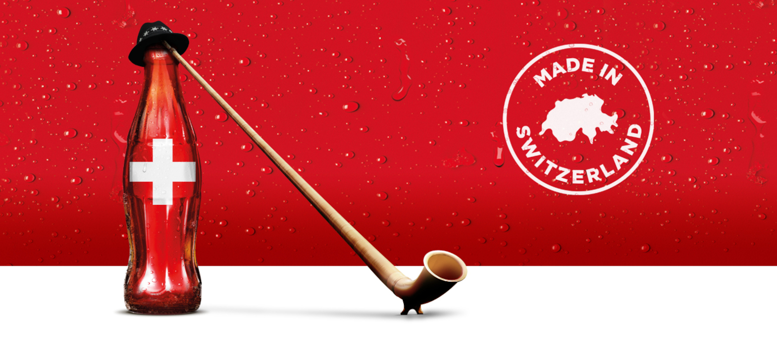Coca-Cola-Flasche, die Alphorn spielt