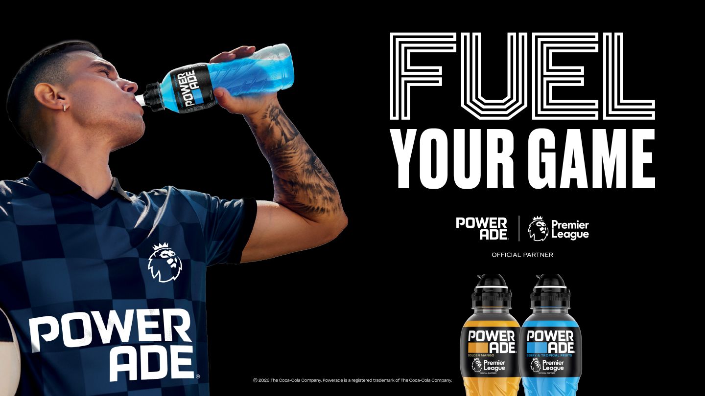 sportsman drinking Powerade on black background