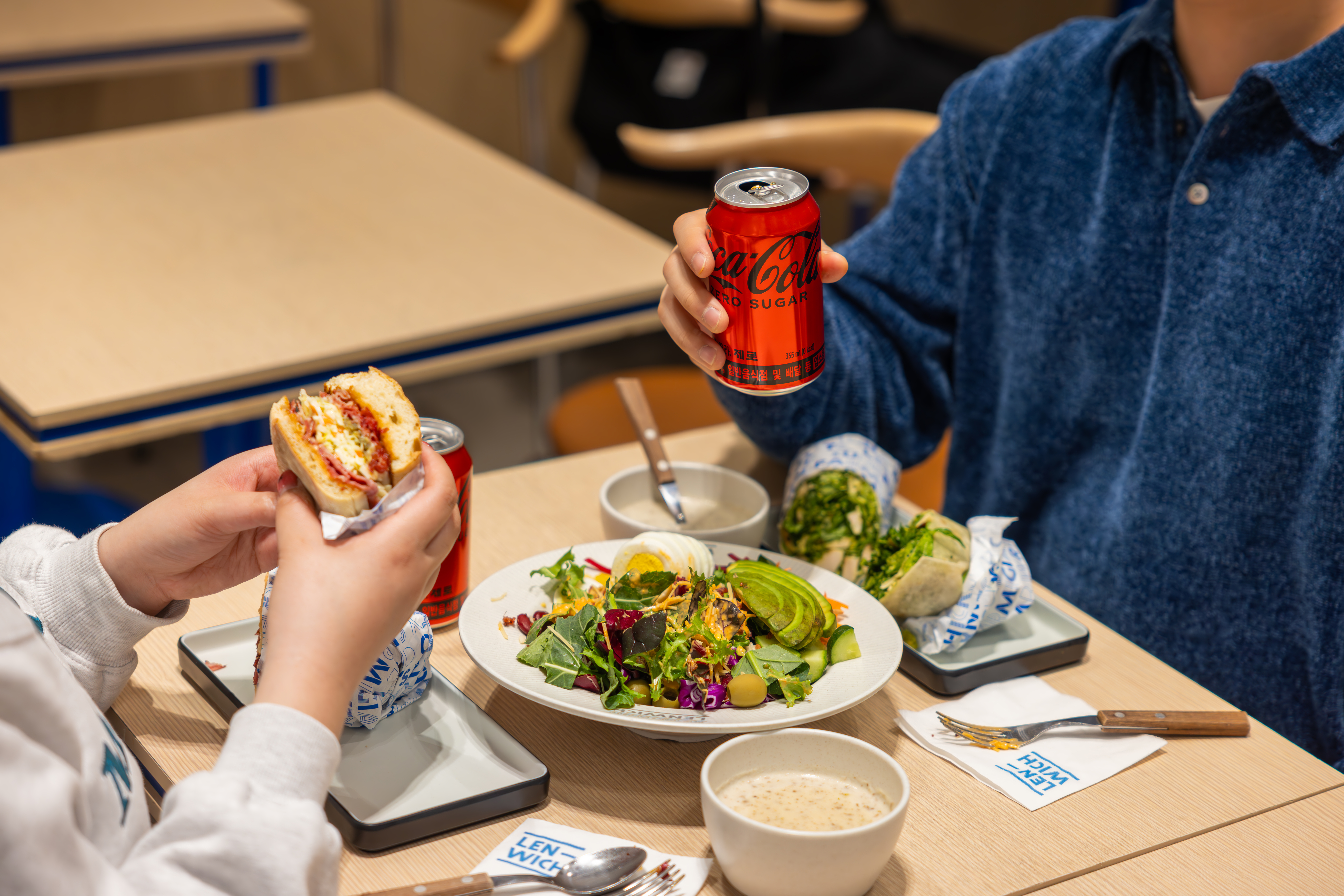 렌위치의 샌드위치와 샐러드를 코카-콜라 제로와 함께 즐기는 사진