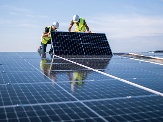 Top view of solar cell panels on a green field