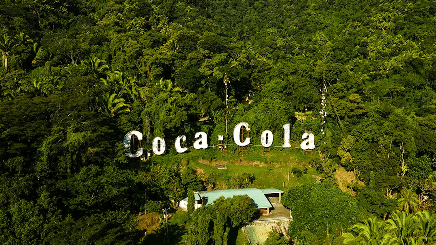 Coca-Cola logo inside a forest