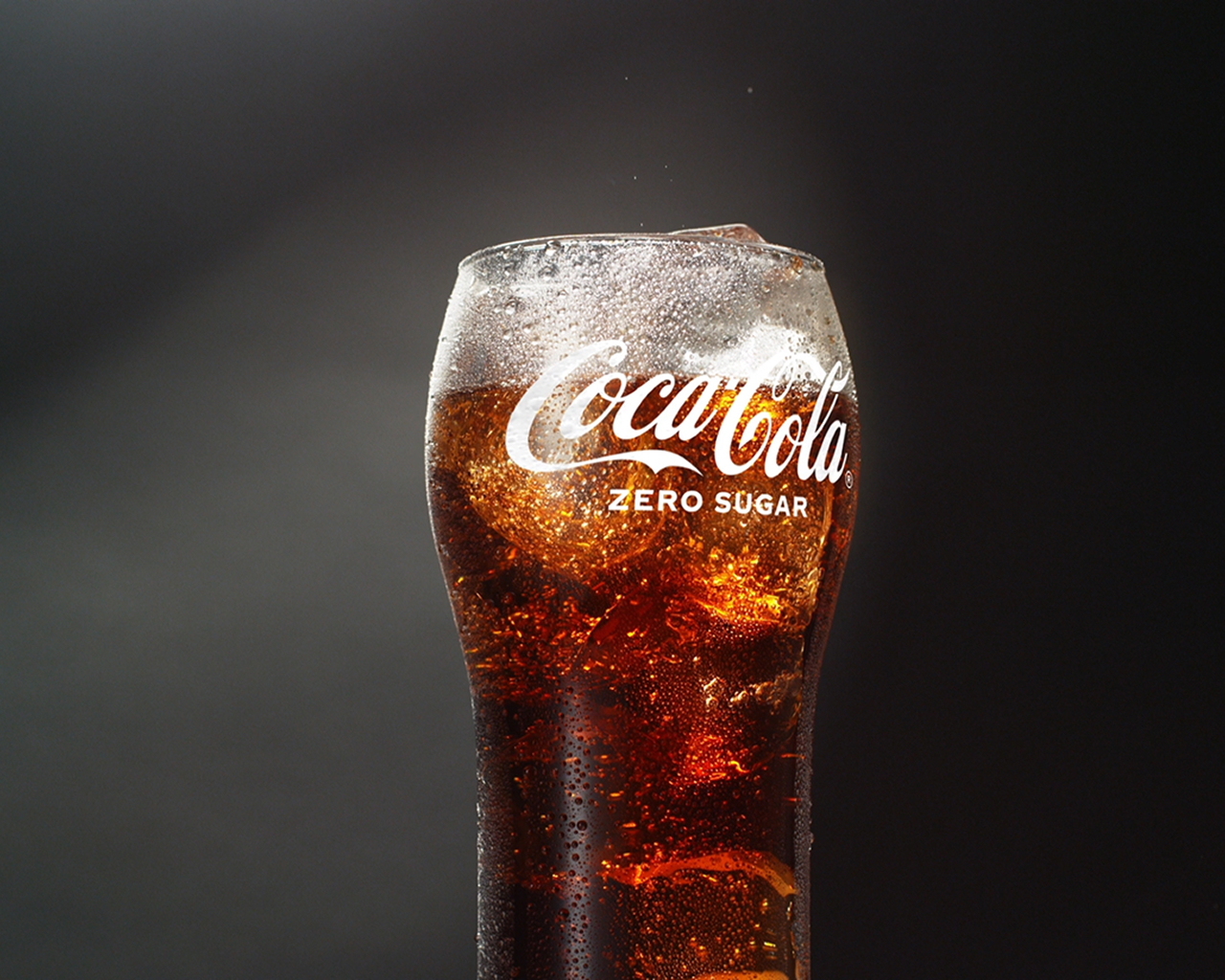 glass full of coca-cola and ice