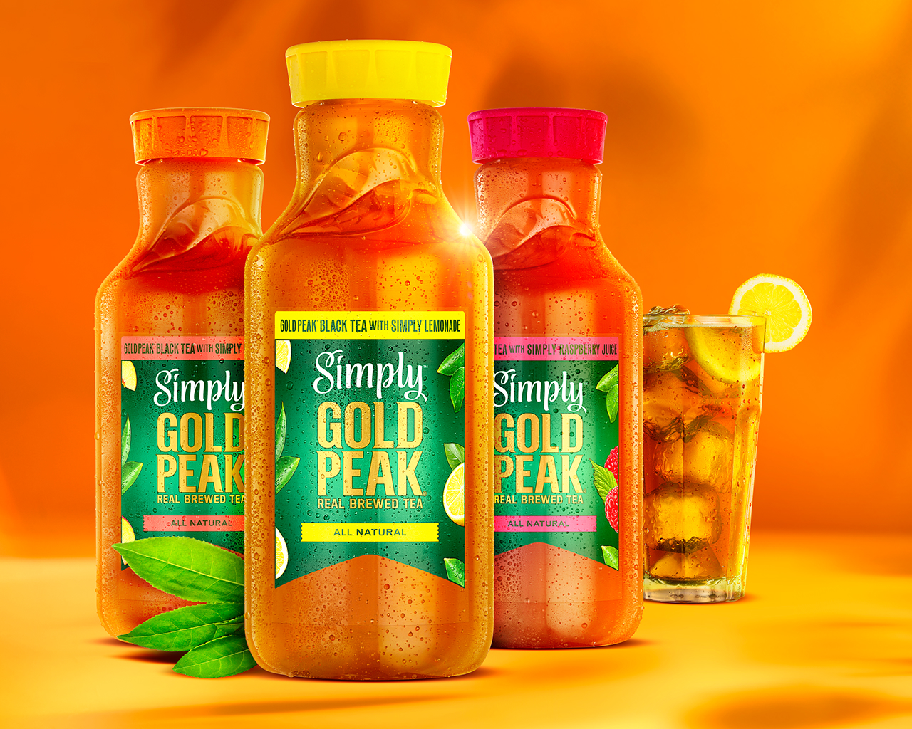 Three bottles of Simply Gold Peak beverages with a filled, chilled glass