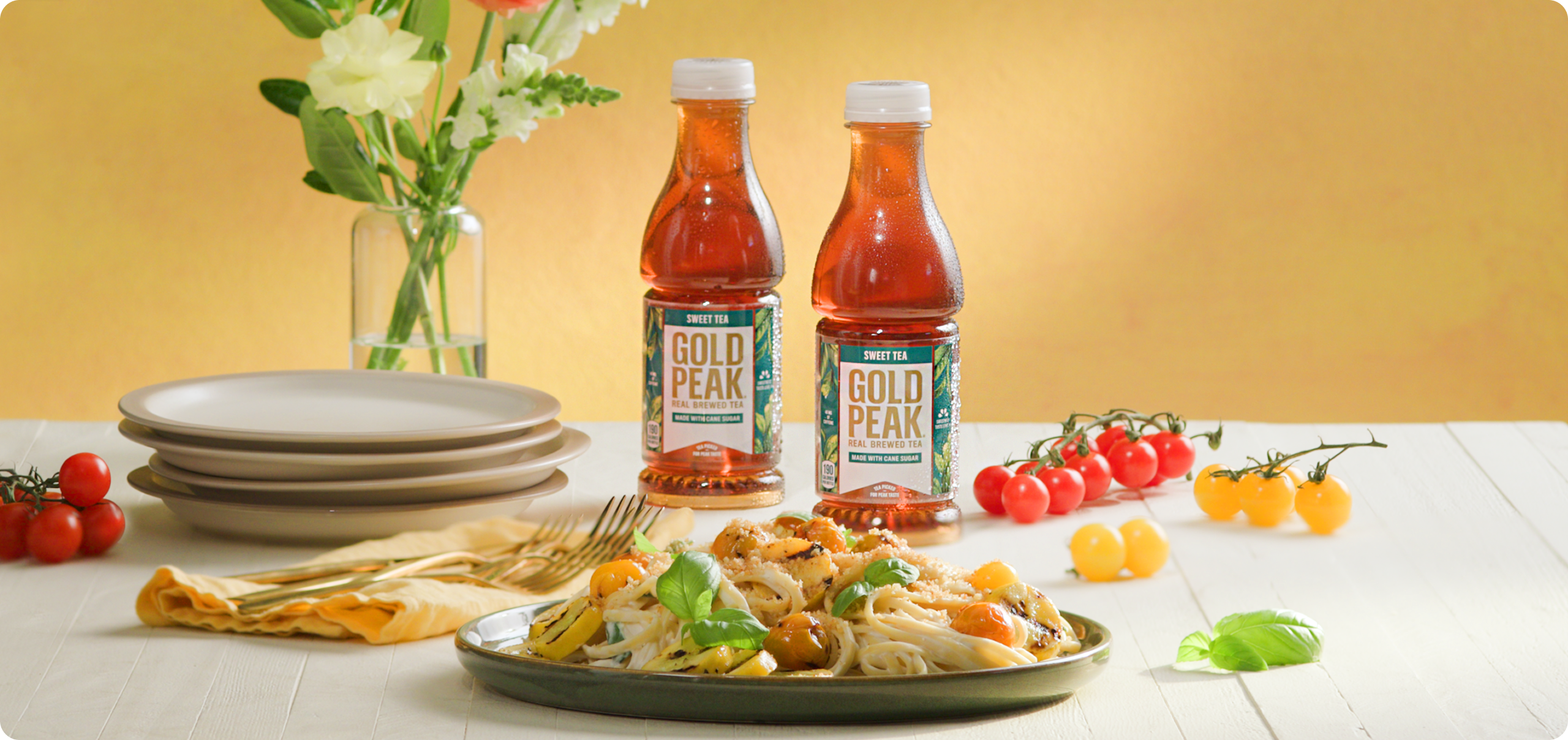 Gold peak tea drinks sitting on a table with food