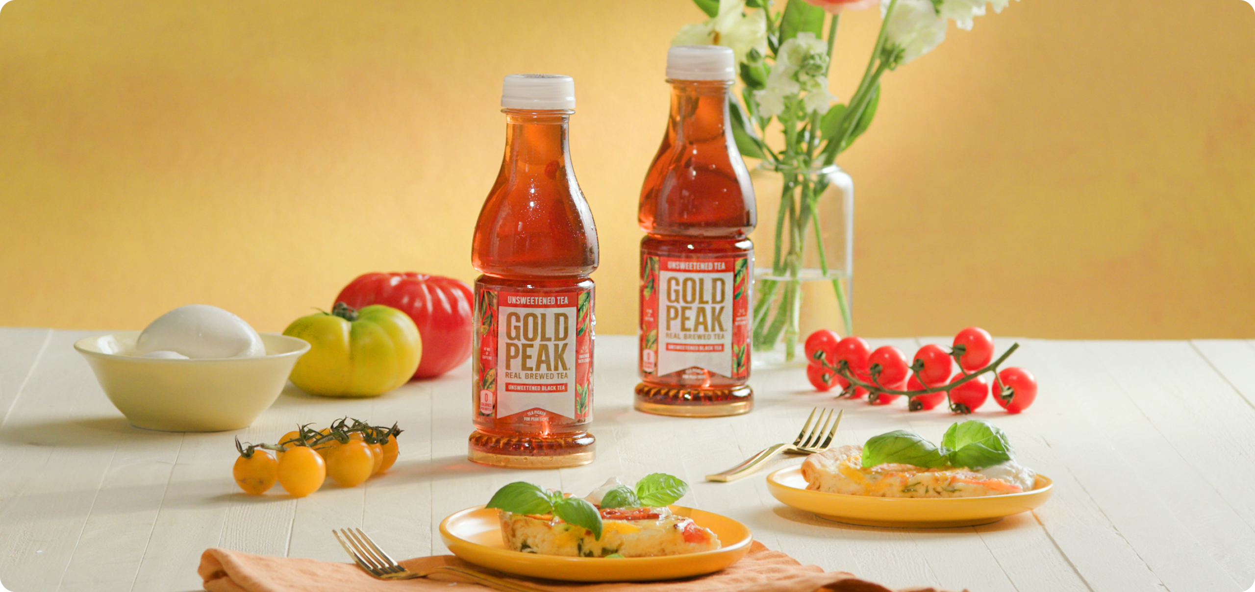 Gold peak tea drinks sitting on a table with food