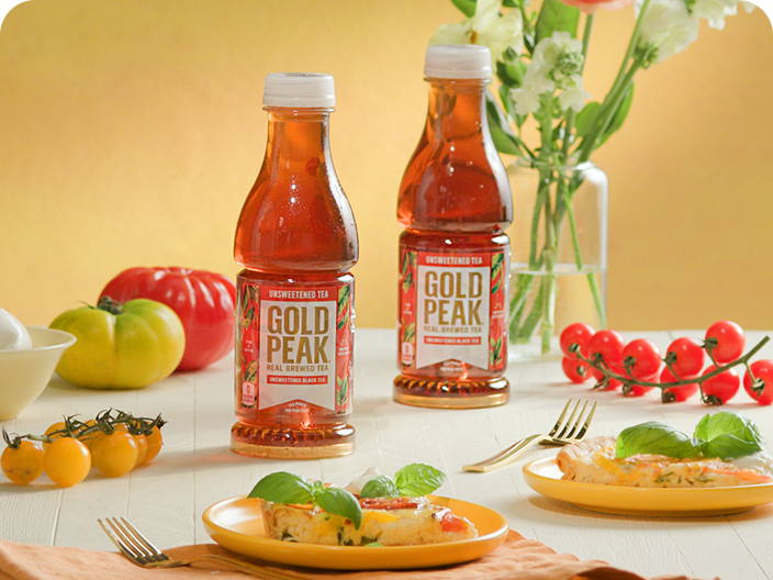 Gold peak tea drinks sitting on a table with food