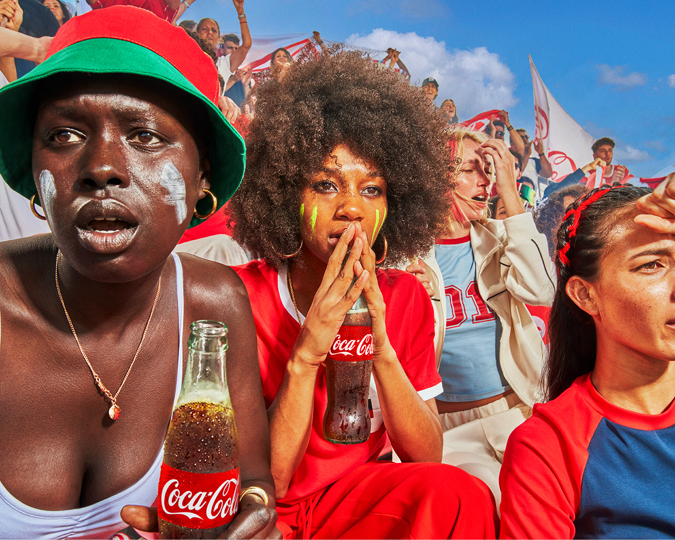 Soccer fans in colorful jerseys and hats cheering in stadium stands, holding Coca‑Cola bottles during FIFA match